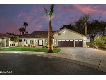 Stunning exterior view of a home boasting a three-car garage, a tile roof, and meticulously manicured landscaping at 7721 N Via De La Montana --, Scottsdale, AZ 85258