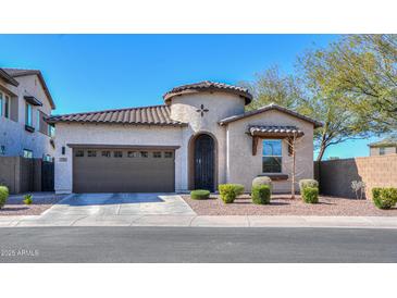 Charming single-story home with a well-manicured front yard and attached two-car garage and turret entry at 139 E Desert Broom Dr, Chandler, AZ 85286