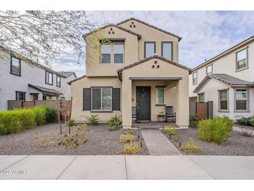 Charming two-story home featuring neutral stucco and manicured landscaping at 1915 W Hide Trl, Phoenix, AZ 85085