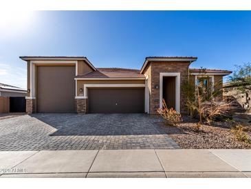 Beautiful single-Gathering home with a well-manicured front yard and a three-car garage at 2019 E Entoro Dr, Casa Grande, AZ 85122