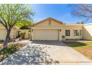 Charming single-story home featuring a two-car garage and a well-manicured front yard at 21 W Ranch Rd, Tempe, AZ 85284