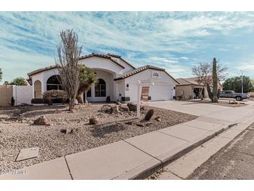 Charming single-story home features desert landscaping and a pristine white exterior in a quiet neighborhood at 441 S Dodge Dr, Chandler, AZ 85225