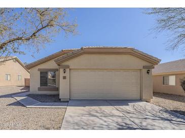 Charming single-story home featuring a two-car garage and a low-maintenance desert landscape at 4517 N 123Rd Dr, Avondale, AZ 85392