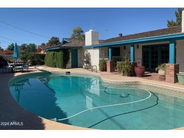 Backyard pool featuring a large inground pool, tile surround, and covered outdoor area at 537 N Jay St, Chandler, AZ 85225