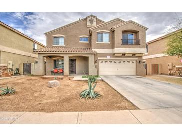 Charming two-story home with a front porch and well-maintained, low maintenance landscaping at 7013 W Branham Ln, Laveen, AZ 85339