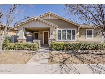 Charming single-story home with a cozy front porch, manicured landscaping, and stone accents at 1170 S Agnes Ln, Gilbert, AZ 85296