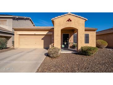 Charming single-story home featuring a front yard with desert landscaping and a two-car garage at 16038 W Acapulco Ln, Surprise, AZ 85379