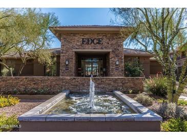 Elegant community center featuring a stone facade with a tranquil water feature and lush landscaping at 20100 N 78Th Pl # 2098, Scottsdale, AZ 85255
