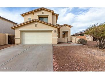 Inviting two-story home featuring a spacious two-car garage and a well-maintained, low maintenance landscape at 25724 W St James Ave, Buckeye, AZ 85326