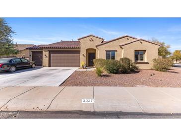 Charming single-story home with a well-maintained front yard and a convenient two-car garage at 3027 N Spring Ln, Casa Grande, AZ 85122