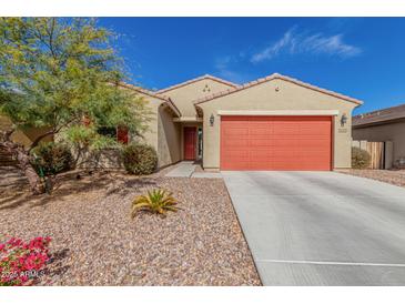 Charming single-story home with desert landscaping, a red garage door, and a matching front door at 4402 W Bush Bean Way, San Tan Valley, AZ 85144