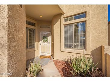 Welcoming front entrance with security door and decorative wreath in a cozy covered entryway at 6730 E Hermosa Vista Dr # 73, Mesa, AZ 85215