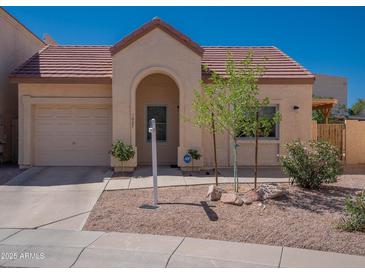 Charming single-story home featuring a well-manicured front yard and inviting covered entryway at 1027 W Julie Dr, Tempe, AZ 85283