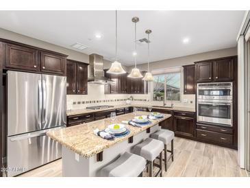 Modern kitchen with stainless steel appliances, granite countertops and center island with seating at 13225 W Skinner Dr, Peoria, AZ 85383