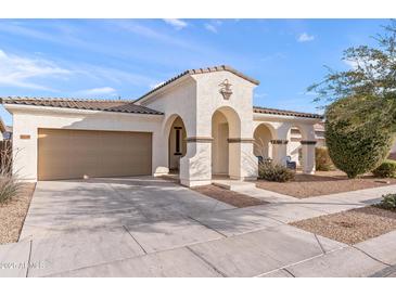 Inviting single-story home featuring arched porch, two-car garage, and low-maintenance desert landscaping at 22538 E Tierra Grande --, Queen Creek, AZ 85142