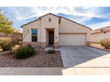 Charming single-story home with a two-car garage and low-maintenance desert landscaping at 22565 W La Pasada Blvd, Buckeye, AZ 85326
