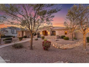 Charming single-story home with desert landscaping and a welcoming front entrance at sunset at 2998 E Waterman Way, Gilbert, AZ 85297