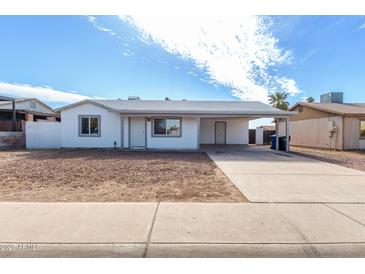 Charming single-story home featuring a covered carport and low-maintenance front yard at 6817 W Palm Ln, Phoenix, AZ 85035