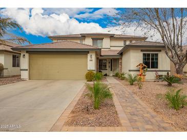 Charming two-story home with a well-manicured front yard and desert-friendly landscaping at 714 W Desert Hills Dr, San Tan Valley, AZ 85143