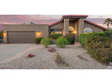 Charming single-story home with a well-manicured front yard and desert landscaping at 10500 E Mission Ln, Scottsdale, AZ 85258