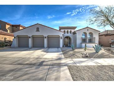 Stunning single-story home with a three-car garage and beautiful desert landscaping in front at 2027 W Calle De Las Estrella --, Phoenix, AZ 85085