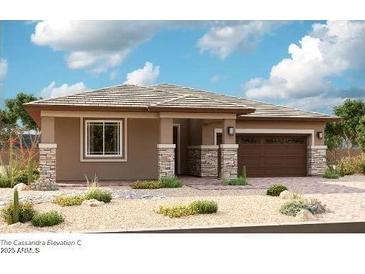 A single-story home with tan siding and stone accents provides a warm, inviting curb appeal at 21952 E Saddle E Ct, Queen Creek, AZ 85142