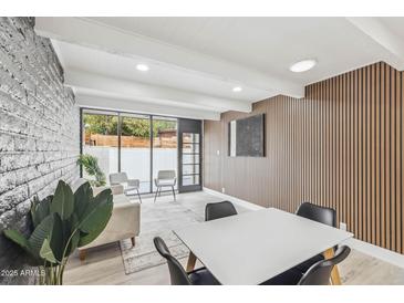 Bright living room features wood-look floors, a large picture window and modern decor at 3002 N 32Nd St # 15, Phoenix, AZ 85018