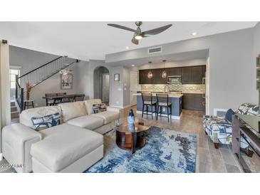 Open-concept living room with modern furnishings and hardwood floors offers comfort at 3935 E Rough Rider Rd # 1349, Phoenix, AZ 85050