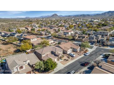 Scenic aerial view of a neighborhood with mountain backdrop, showcasing the home's desirable location at 4624 W Heyerdahl Ct, New River, AZ 85087
