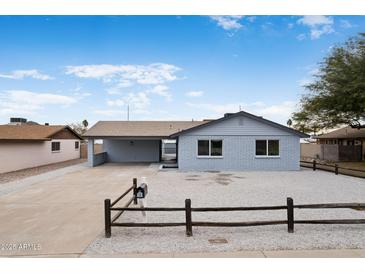 Charming single-story home with gray siding, carport, and well-maintained gravel yard at 1101 E Cheryl Dr, Phoenix, AZ 85020