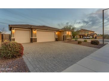 Charming home with a three car garage and paver driveway, and manicured landscaping at 13341 W Yearling Rd, Peoria, AZ 85383