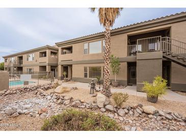 Lovely condo exterior with desert landscaping, pool access, and private balconies at 16734 E La Montana Dr # 103, Fountain Hills, AZ 85268