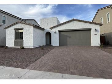 Charming single Gathering home featuring a two-car garage and low maintenance landscaping at 18032 W Vogel Ave, Goodyear, AZ 85338