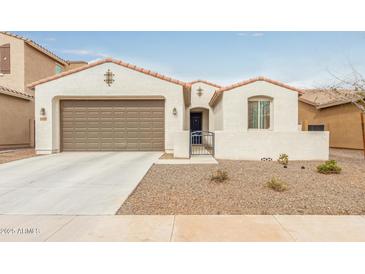 Charming single-story home featuring a two-car garage, low-maintenance landscaping, and secure gated entry at 18248 W Carlota Ln, Surprise, AZ 85387