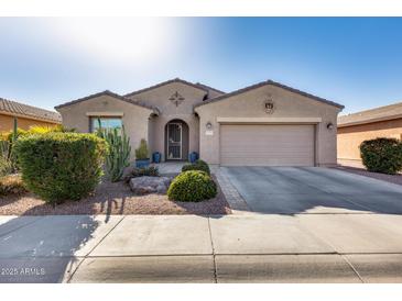 Charming single-story home featuring desert landscaping, a two-car garage, and covered front entry at 20194 N Riverbank Rd, Maricopa, AZ 85138