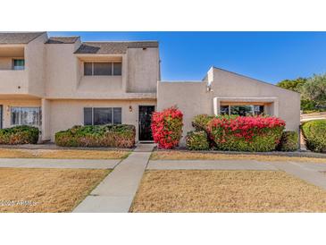 Charming townhome featuring desert landscaping and colorful flowering bushes at 2233 W Farmdale Ave # 2, Mesa, AZ 85202