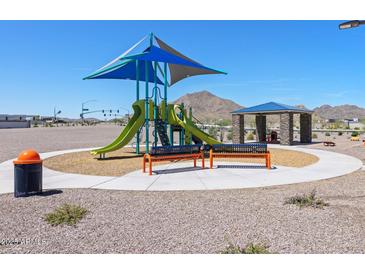 Community playground with vibrant play structure, benches, picnic shelter and mountain views at 4812 W Hunter Trl, San Tan Valley, AZ 85144