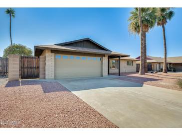 Charming single-story home featuring a two-car garage and desert landscaping at 5513 W Tierra Buena Ln, Glendale, AZ 85306