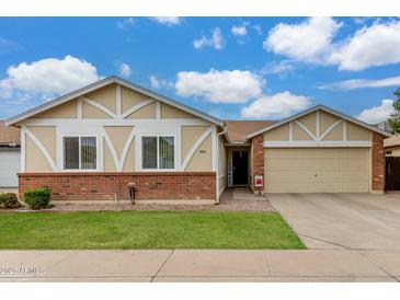 Charming single-story home featuring well-kept lawn and a two-car garage at 6335 E Brown Rd # 1081, Mesa, AZ 85205