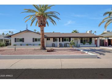 Charming single-story home featuring a well-maintained yard with mature palm trees at 6634 N 16Th Dr, Phoenix, AZ 85015