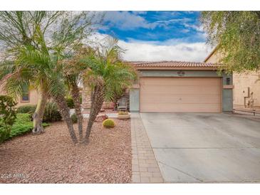 Charming single-story home with a well-manicured front yard and a two-car garage at 7322 S Sunset Way, Buckeye, AZ 85326