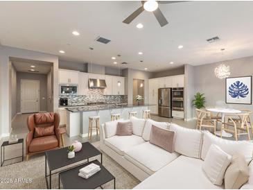 Inviting open-concept living space featuring a modern kitchen, comfortable seating, and stylish décor at 7472 E Paraiso Dr, Scottsdale, AZ 85255