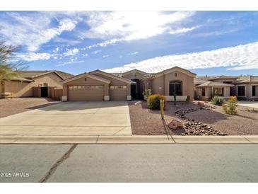 Beautiful single-story home featuring a three-car garage and desert landscaping at 8157 E Apache Plumb Dr, Gold Canyon, AZ 85118