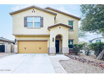 Two-story home featuring a two-car garage, covered entry, and desert landscaping in a well-maintained community at 10825 W El Cortez Pl, Peoria, AZ 85383