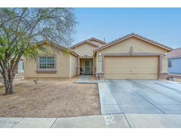 Attractive single-Gathering home featuring a two-car garage, neutral stucco, and low-maintenance desert landscaping at 12425 N 127Th Dr, El Mirage, AZ 85335