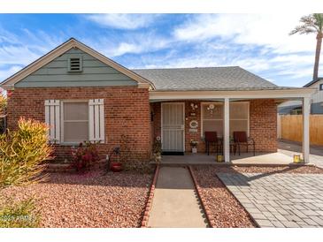 Charming brick home with a cozy front porch and well-maintained landscaping under a bright blue sky at 2315 N 12Th St, Phoenix, AZ 85006