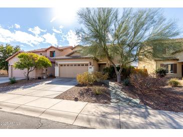 Charming single-Gathering home featuring a well-maintained yard and a two-car garage at 26111 W Yukon Dr, Buckeye, AZ 85396