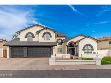 Stunning two-story home with a three-car garage and beautiful landscaping at 5010 E Nisbet Rd, Scottsdale, AZ 85254