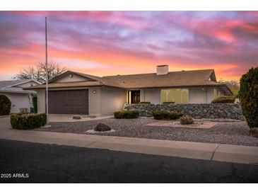 Charming single-story home with a desert landscape, attached garage and neutral color palette at 10956 W Meade Dr, Sun City, AZ 85351