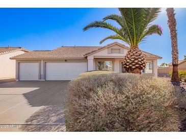 Charming single-story home featuring a three car garage and mature desert landscaping at 1227 W 12Th Ave, Apache Junction, AZ 85120